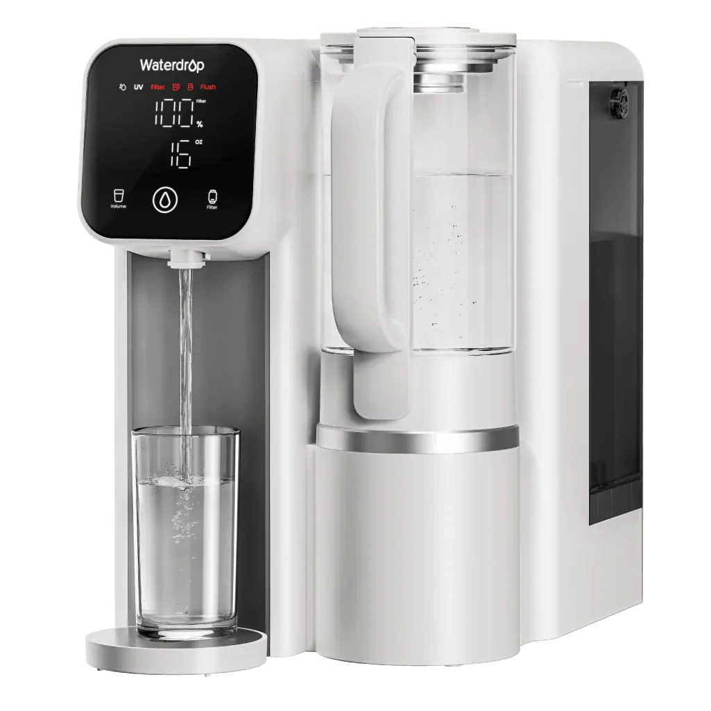 White plastic Waterdrop countertop filter dispensing water into a glass, featuring a digital display and glass carafe.