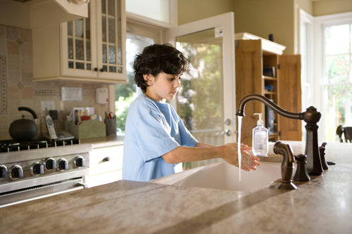 A boy washing hands