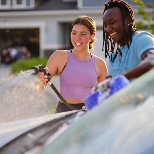 Fun Couple Washing Car Together