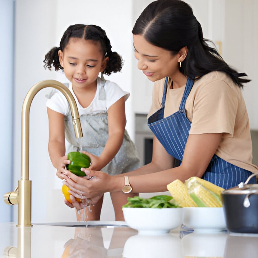 Mom With Young Girl Washing Vegetables
