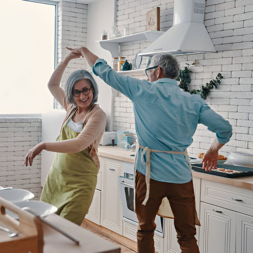 Senior couple dancing in kitchen