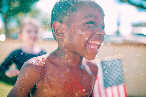 Happy Boy Playing With Water