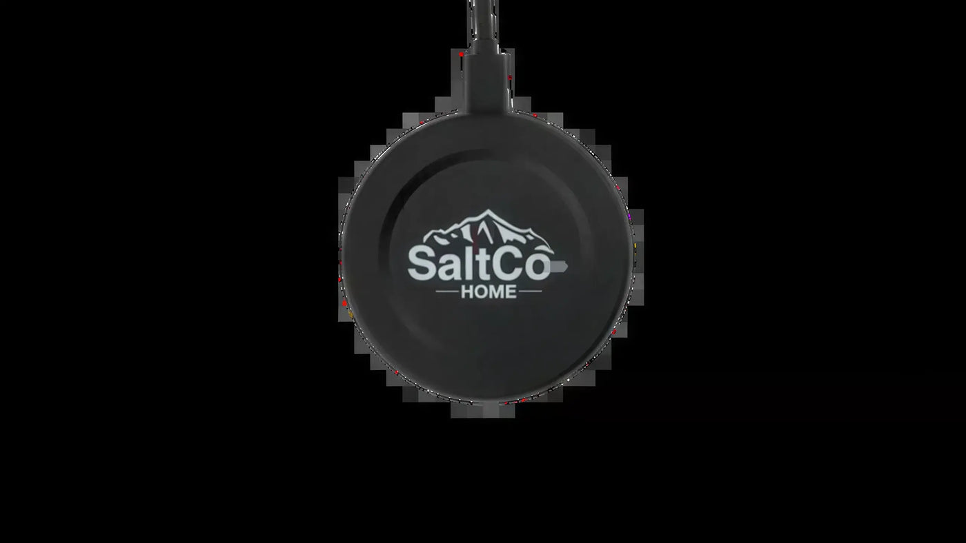 Round black plastic SaltCo HOME sensor with a mountain logo and attached cable, centered on a black background.